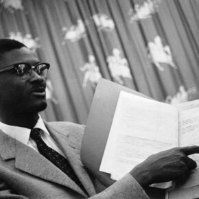 Premier Patrice Lumumba at the press conference he held in Leopoldville, Congo on Sept. 20, 1960. It was his first press conference since his alleged arrest, Lumumba is showing the agreement he said had been signed between himself and President Joseph Kasavubu on September 17th.   Kasavubu immediately denied having signed any such agreement. (AP Photo/H. Babout)